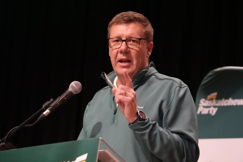 A man speaks at a podium.