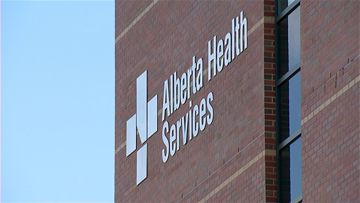 alberta-health-services-sign An Alberta Health Services sign on a brick building.