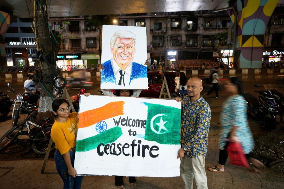 aptopix-india-pakistan-1 People hold up a signs depicting flags, a person's portrait and the words, 'Welcome to ceasefire.'