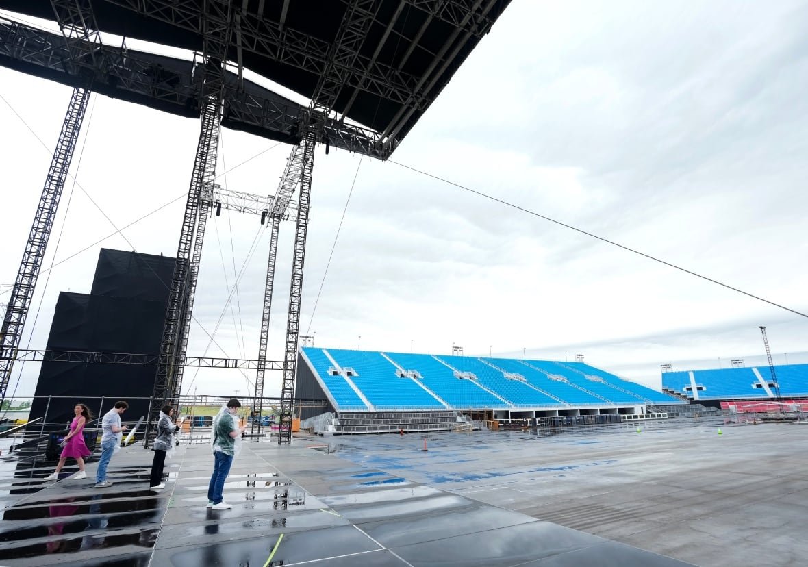 music-rogers-stadium-20250626-1 People stand on a stage.