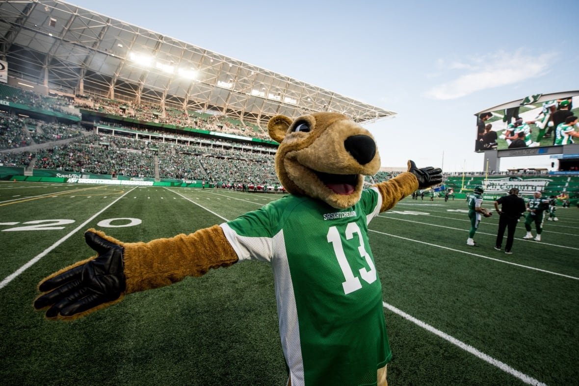 fbo-cfl-stampeders-riders-20190706 A gopher mascot stands on a football field with arms raised.