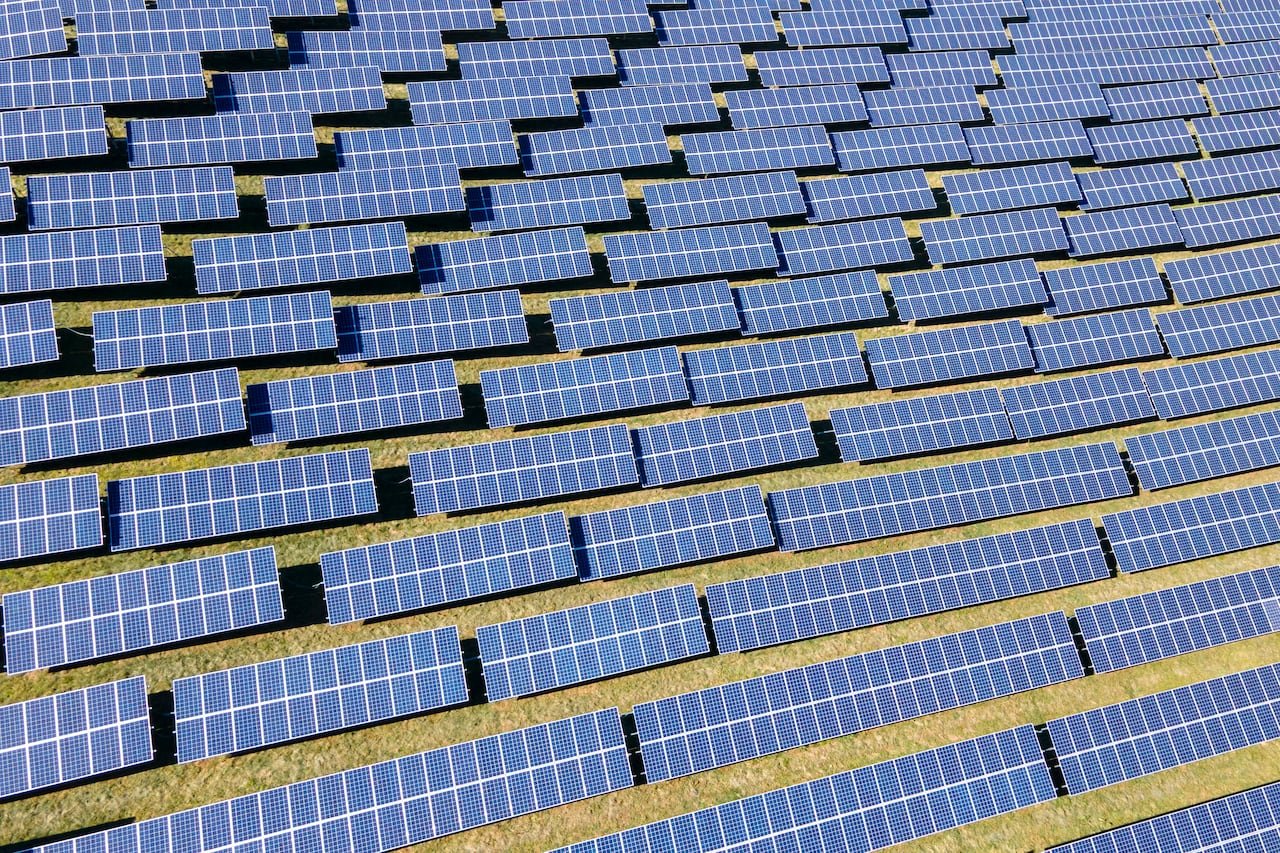 default-881 Several solar panels cover a field.