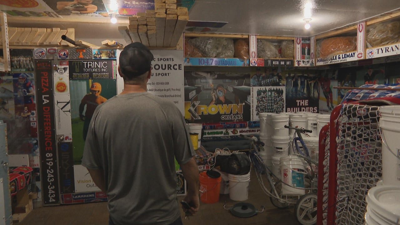 Man examining posters in a skate shack