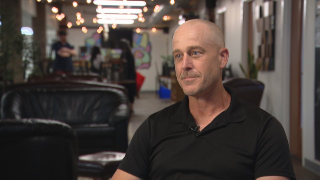 Man in a black shirt sitting down