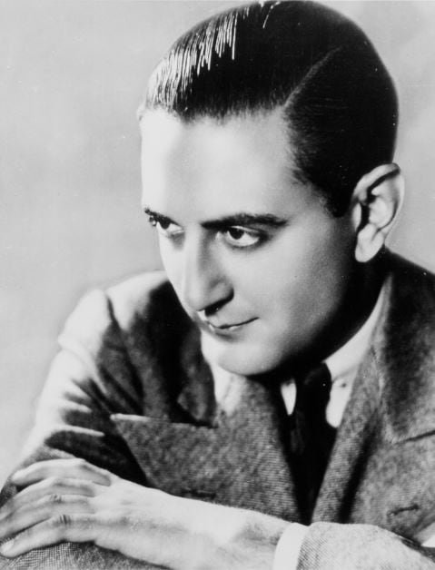 A man poses in a black and white photo