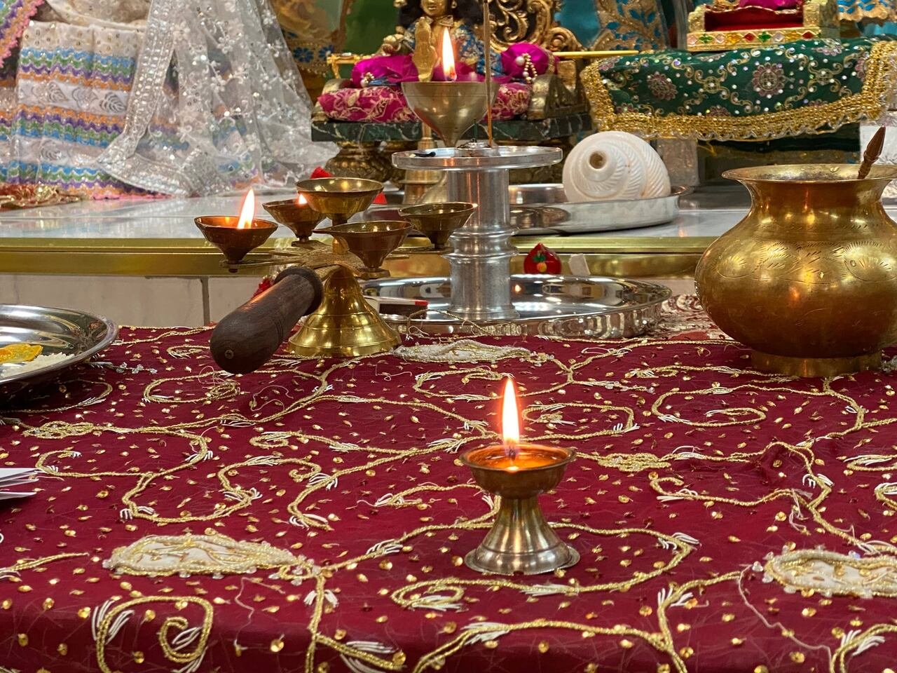 Diyas are lit at the altar for Diwali
