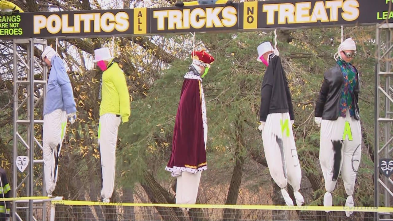 Dolls are seen hanging from nooses in a homemade gallows