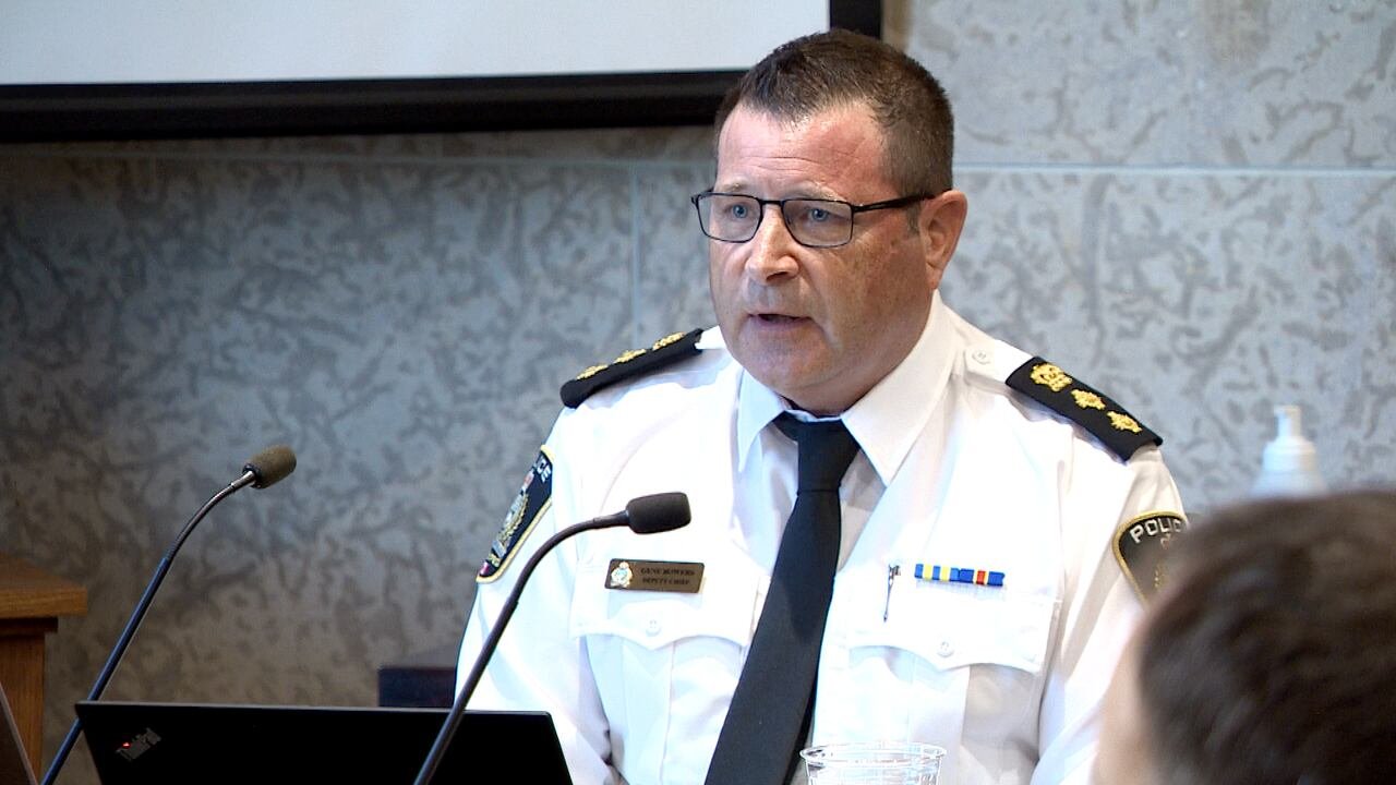 default-608 A man in a white uniform sits in front of a microphone.